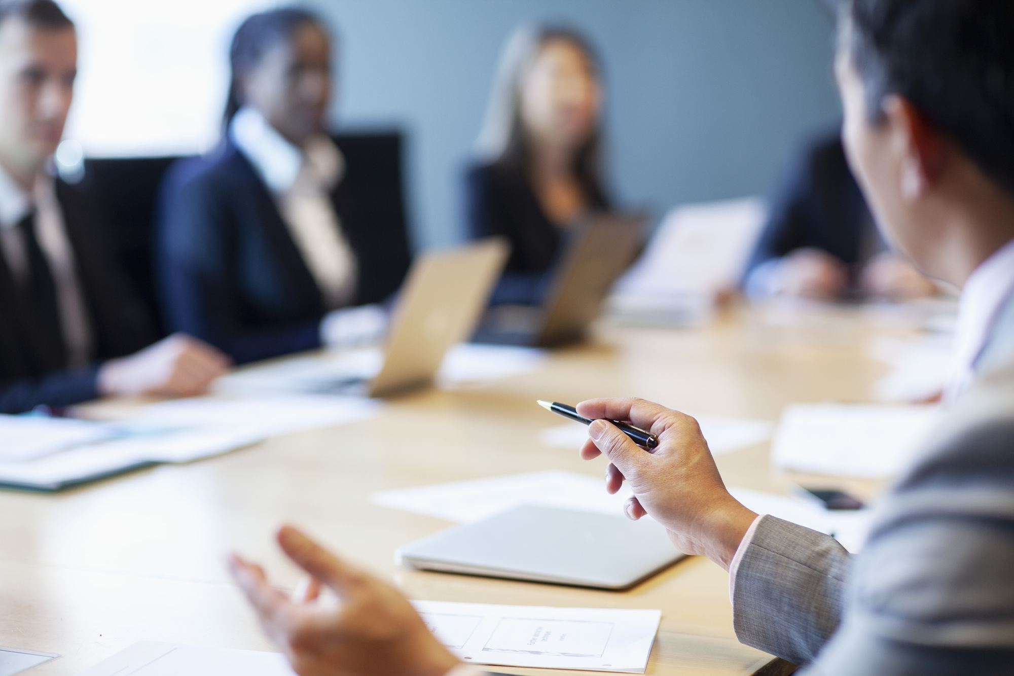 A leadership team in discussion around a conference table