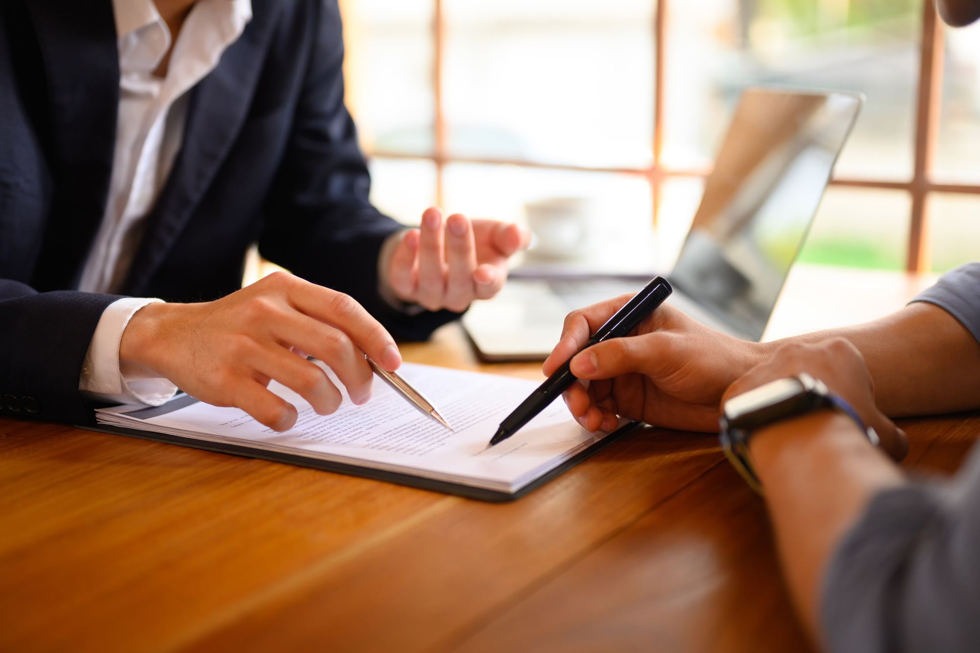 Two people reviewing and signing an agreement