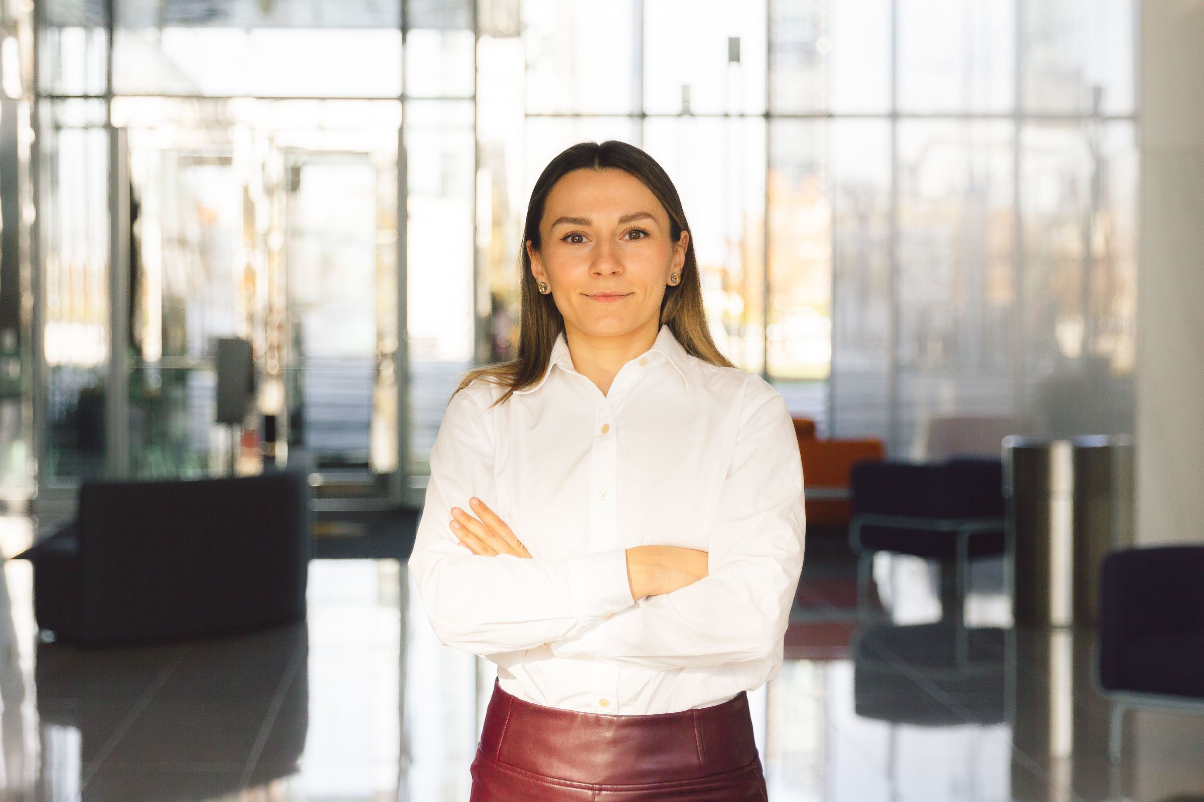 A confident executive standing in a modern office lobby